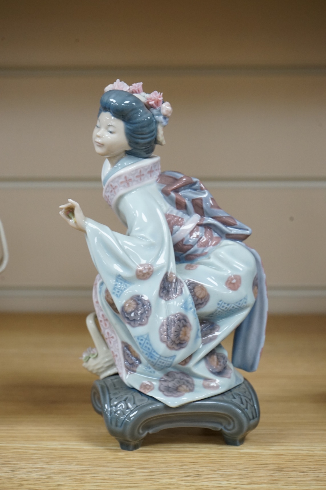 Three Lladro models of seated Geisha. Tallest 23cm
